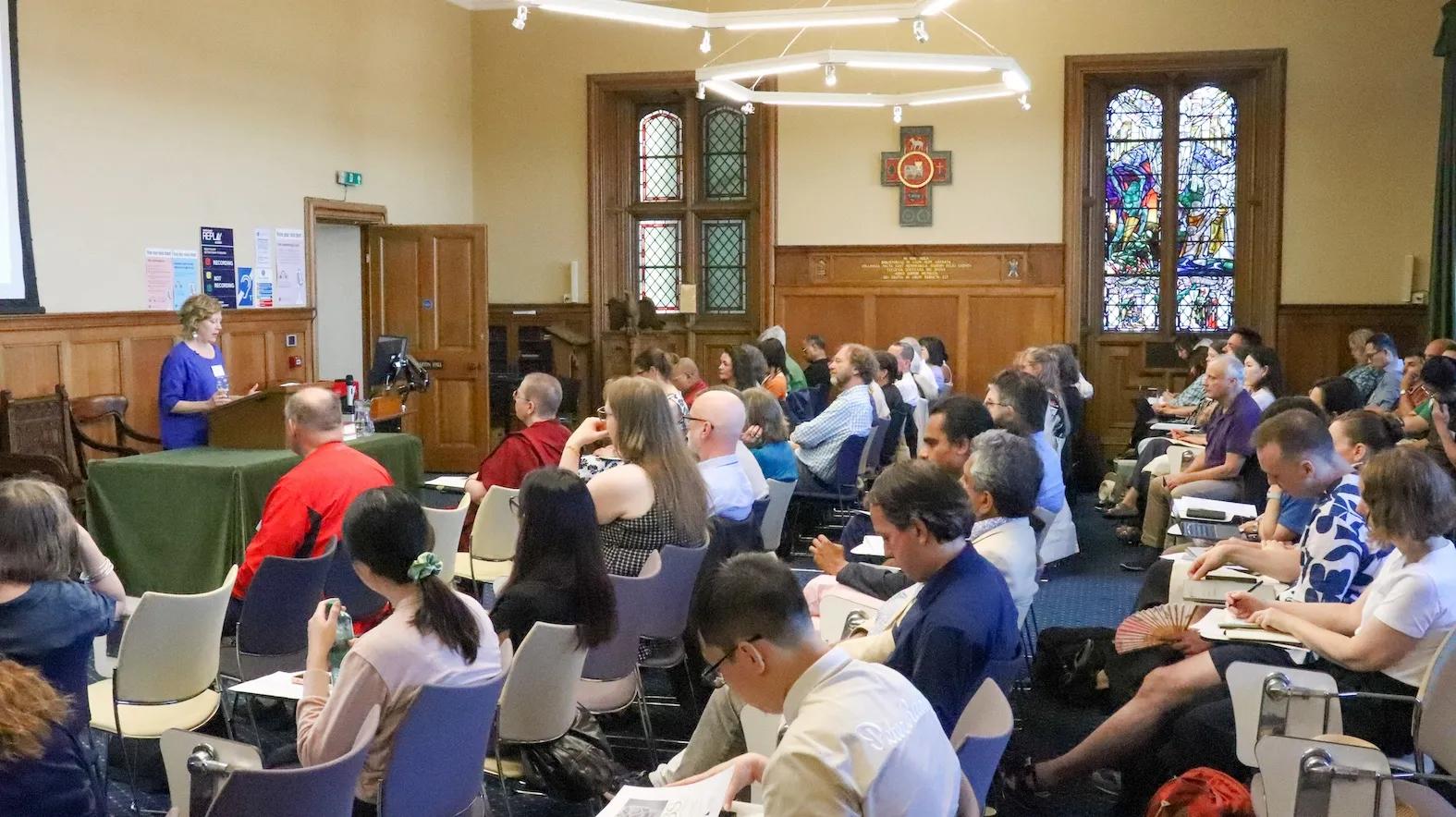 a speaker addressing a room full of people